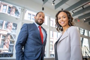 Two business professionals in glass office