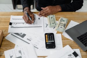 Person sitting at table going over payroll files